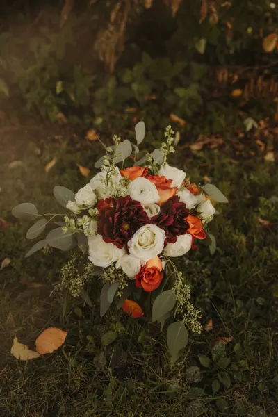 Autumn bouquet with white roses, burgundy dahlias and eucalyptus — Prior Lake, Minnesota wedding photography by Emma Ziegler, Honey Deww Photography