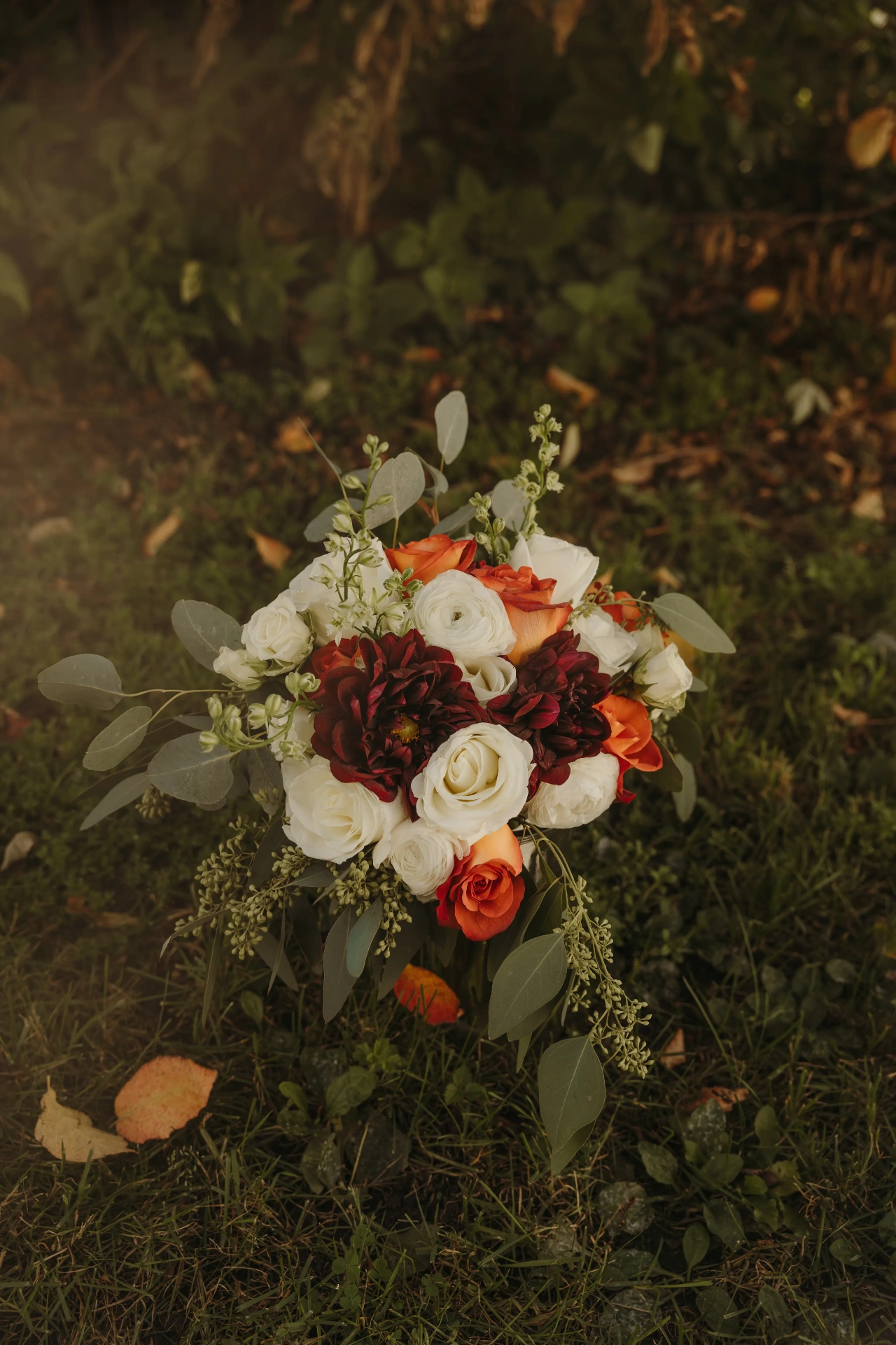 Autumn bouquet with white roses, burgundy dahlias and eucalyptus