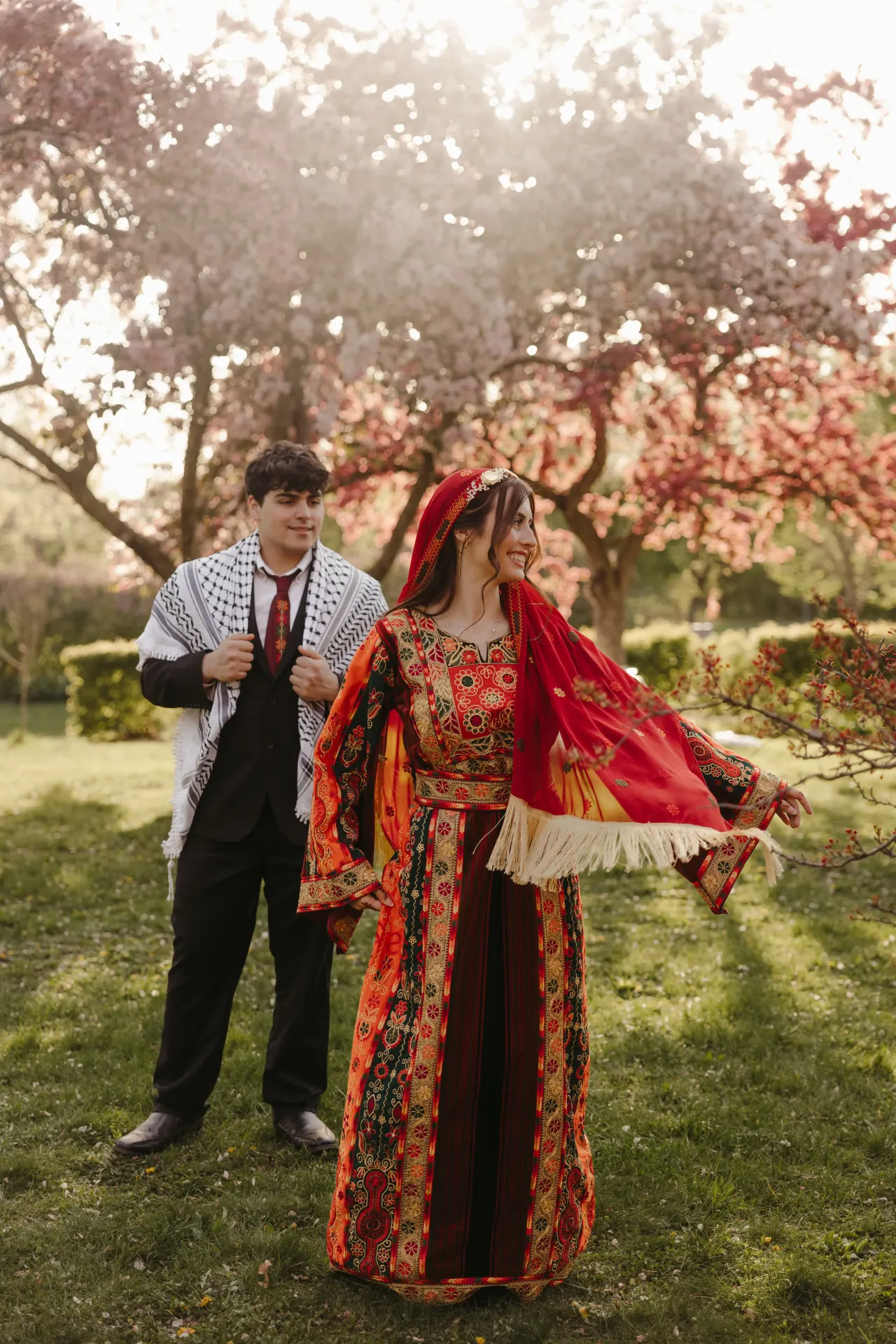 Bride twirling an embroidered thobe as she and her groom walk beneath blossoms — Minneapolis & Twin Cities wedding photography by Emma Ziegler, Honey Deww Photography (Minnesota)