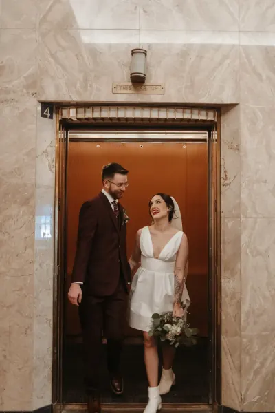 Bride and groom stepping out of vintage elevator — Prescott, WI, Minnesota wedding photography by Emma Ziegler, Honey Deww Photography