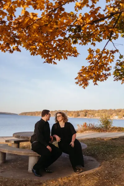 Couple on bench under golden fall leaves by the lake — Tonka Bay, Minnesota wedding photography by Emma Ziegler, Honey Deww Photography