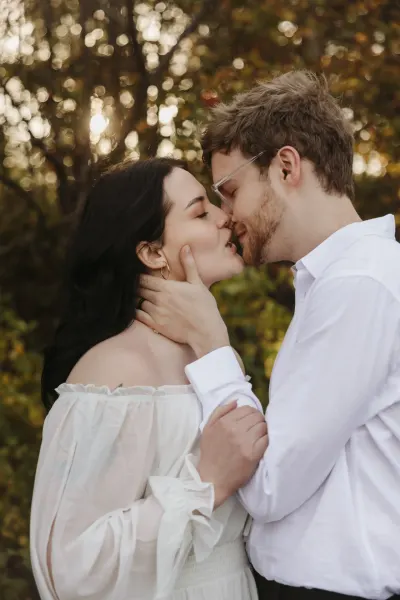 Couple kissing in golden bokeh light among autumn trees — Rogers, MN, Minnesota wedding photography by Emma Ziegler, Honey Deww Photography