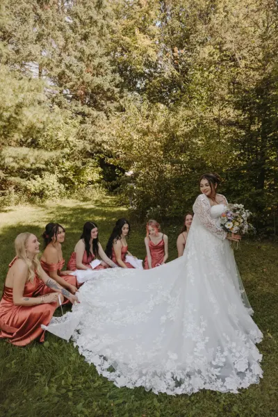 Bride with bridesmaids in rust dresses admiring her gown — Edina, Minnesota wedding photography by Emma Ziegler, Honey Deww Photography