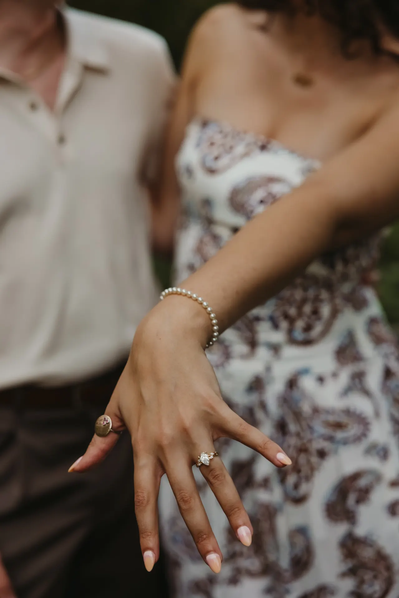Engagement ring and a pearl bracelet on an outstretched hand — Minneapolis & Twin Cities wedding photography by Emma Ziegler, Honey Deww Photography (Minnesota)