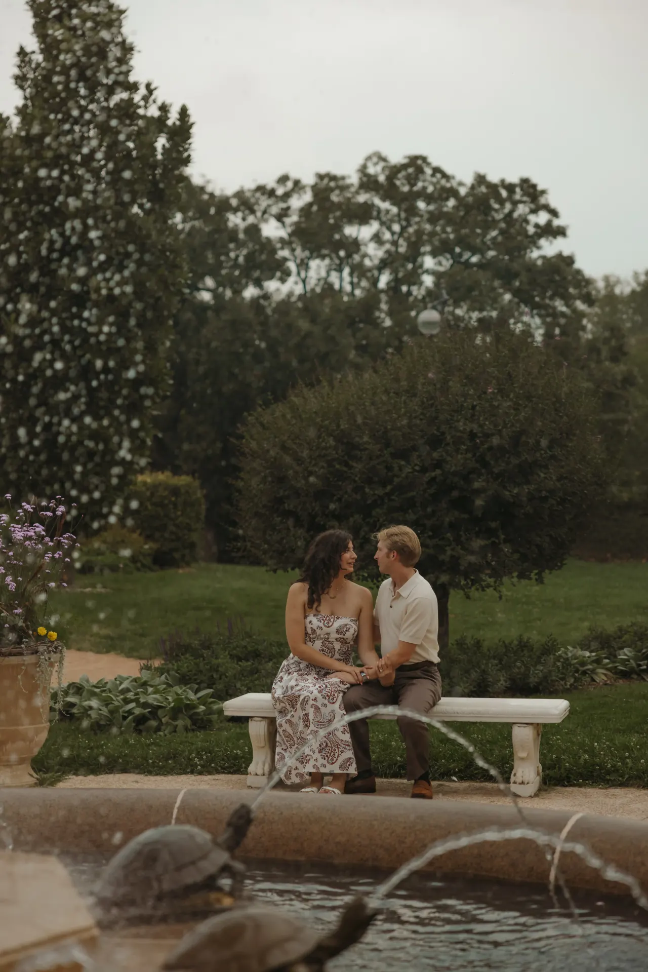 Couple sitting together on a stone bench beside a fountain in a formal garden — Minneapolis & Twin Cities wedding photography by Emma Ziegler, Honey Deww Photography (Minnesota)
