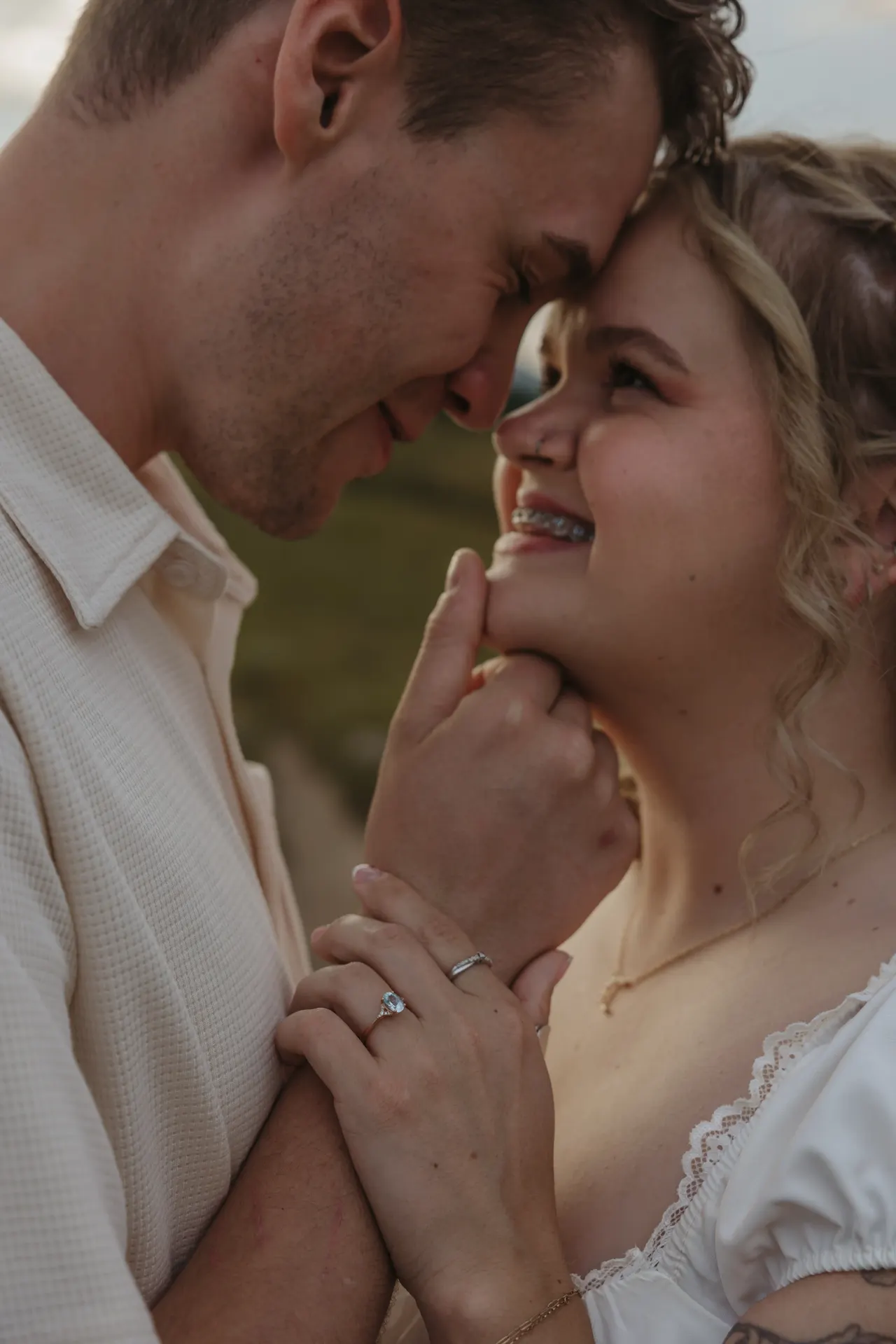 Close portrait of a couple forehead to forehead, his hand at her chin, both laughing — Minneapolis & Twin Cities wedding photography by Emma Ziegler, Honey Deww Photography (Minnesota)