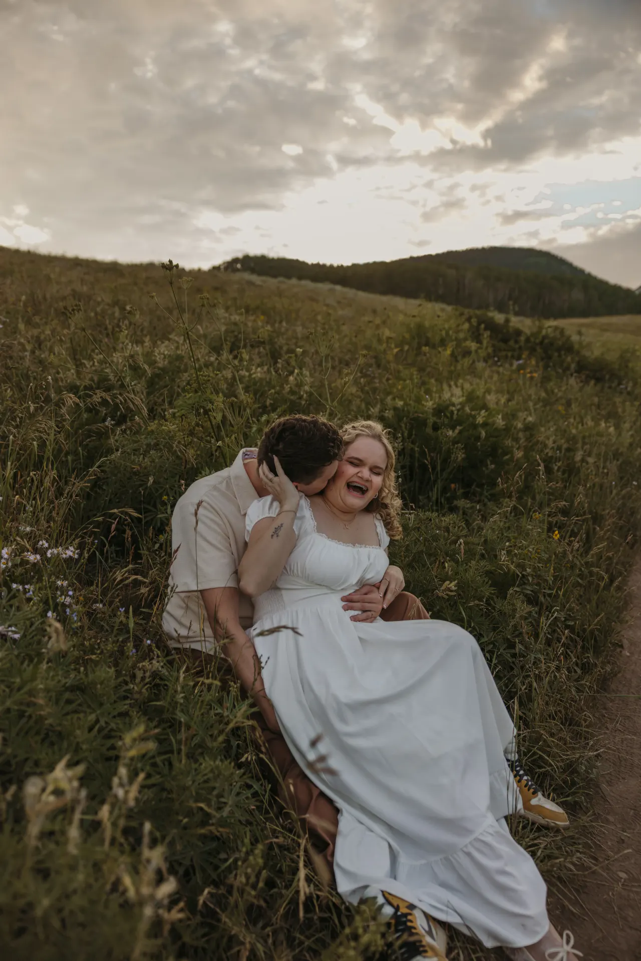 Couple lying together laughing in a mountain meadow at dusk — Minneapolis & Twin Cities wedding photography by Emma Ziegler, Honey Deww Photography (Minnesota)