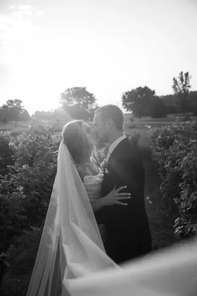 Bride and groom kissing in vineyard in black and white — St. Cloud, Minnesota wedding photography by Emma Ziegler, Honey Deww Photography