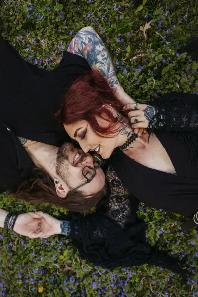 Tattooed couple lying in purple wildflowers from above — St. Cloud, Minnesota wedding photography by Emma Ziegler, Honey Deww Photography