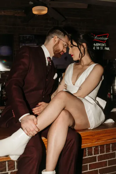 Couple in moody bar setting with neon signs — Woodville, Minnesota wedding photography by Emma Ziegler, Honey Deww Photography