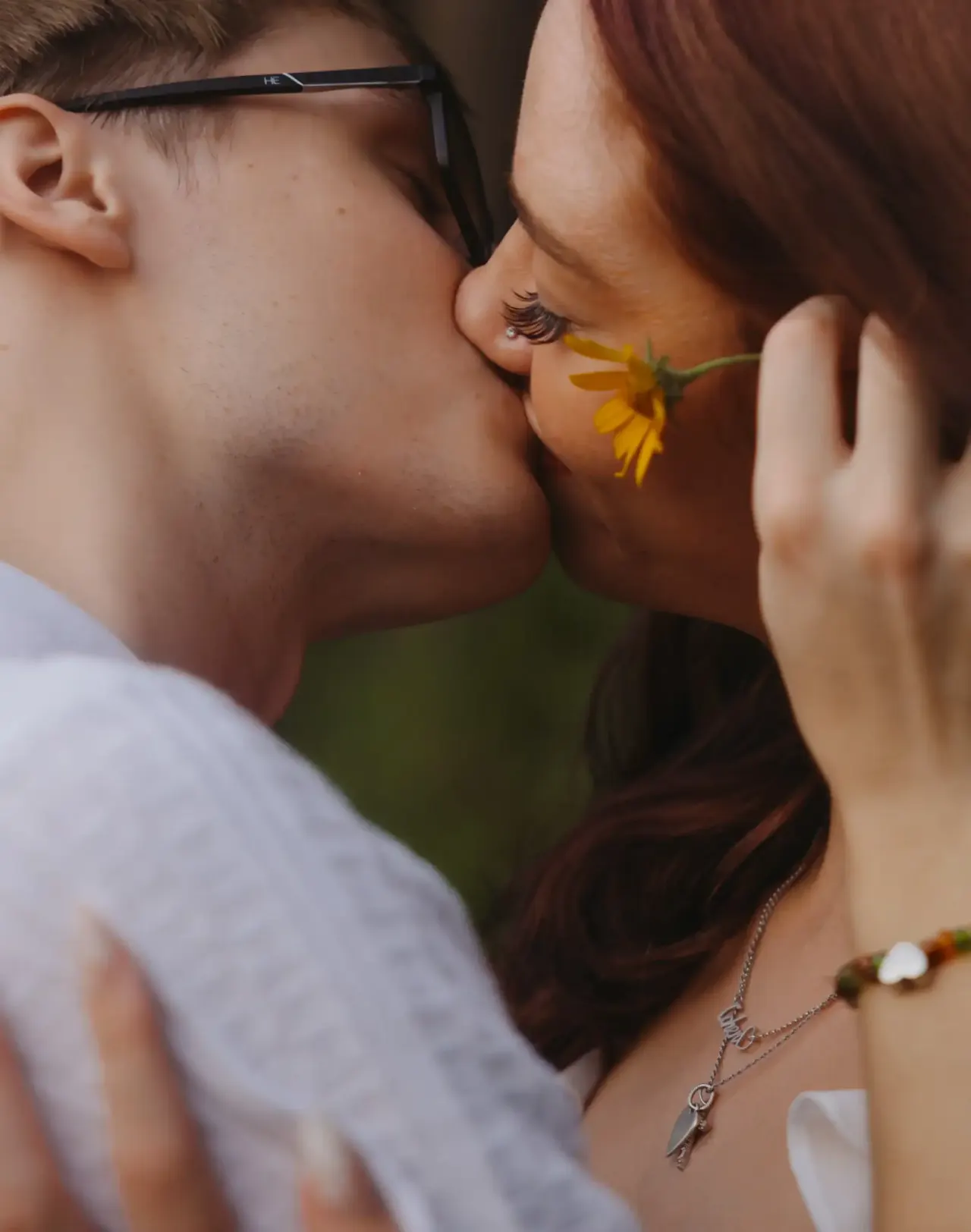Couple kissing with a yellow wildflower held between them — Minneapolis & Twin Cities wedding photography by Emma Ziegler, Honey Deww Photography (Minnesota)