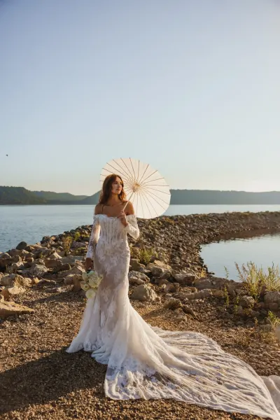 Bride in lace gown with parasol on rocky lakeshore — Lake Elmo, Minnesota wedding photography by Emma Ziegler, Honey Deww Photography