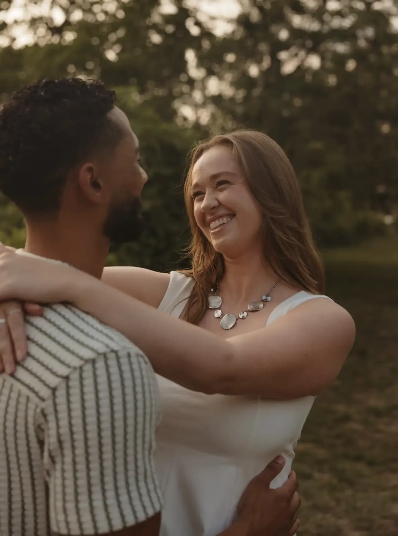 Couple laughing together in a park at golden hour — Minneapolis & Twin Cities wedding photography by Emma Ziegler, Honey Deww Photography (Minnesota)