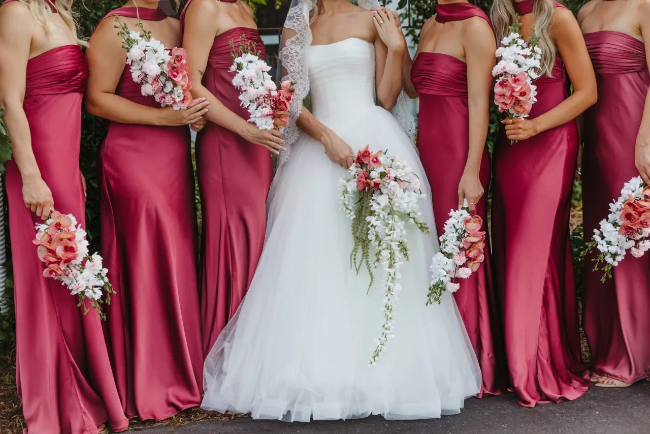 Bridesmaids in berry satin standing in a row with the bride and their bouquets — Minneapolis & Twin Cities wedding photography by Emma Ziegler, Honey Deww Photography (Minnesota)