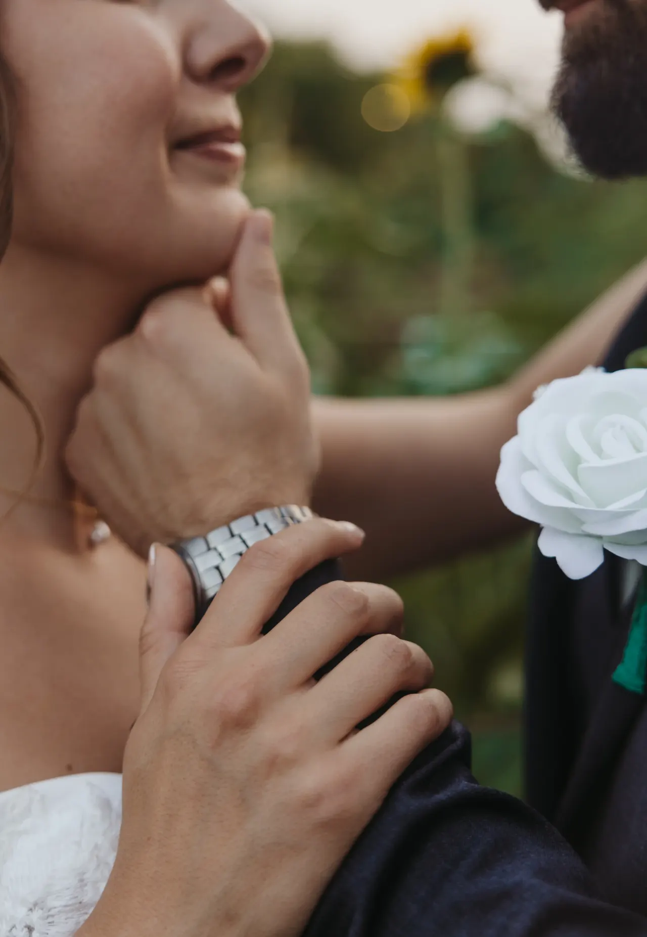 Close view of a groom's hand at his bride's chin, white rose boutonniere in frame — Minneapolis & Twin Cities wedding photography by Emma Ziegler, Honey Deww Photography (Minnesota)