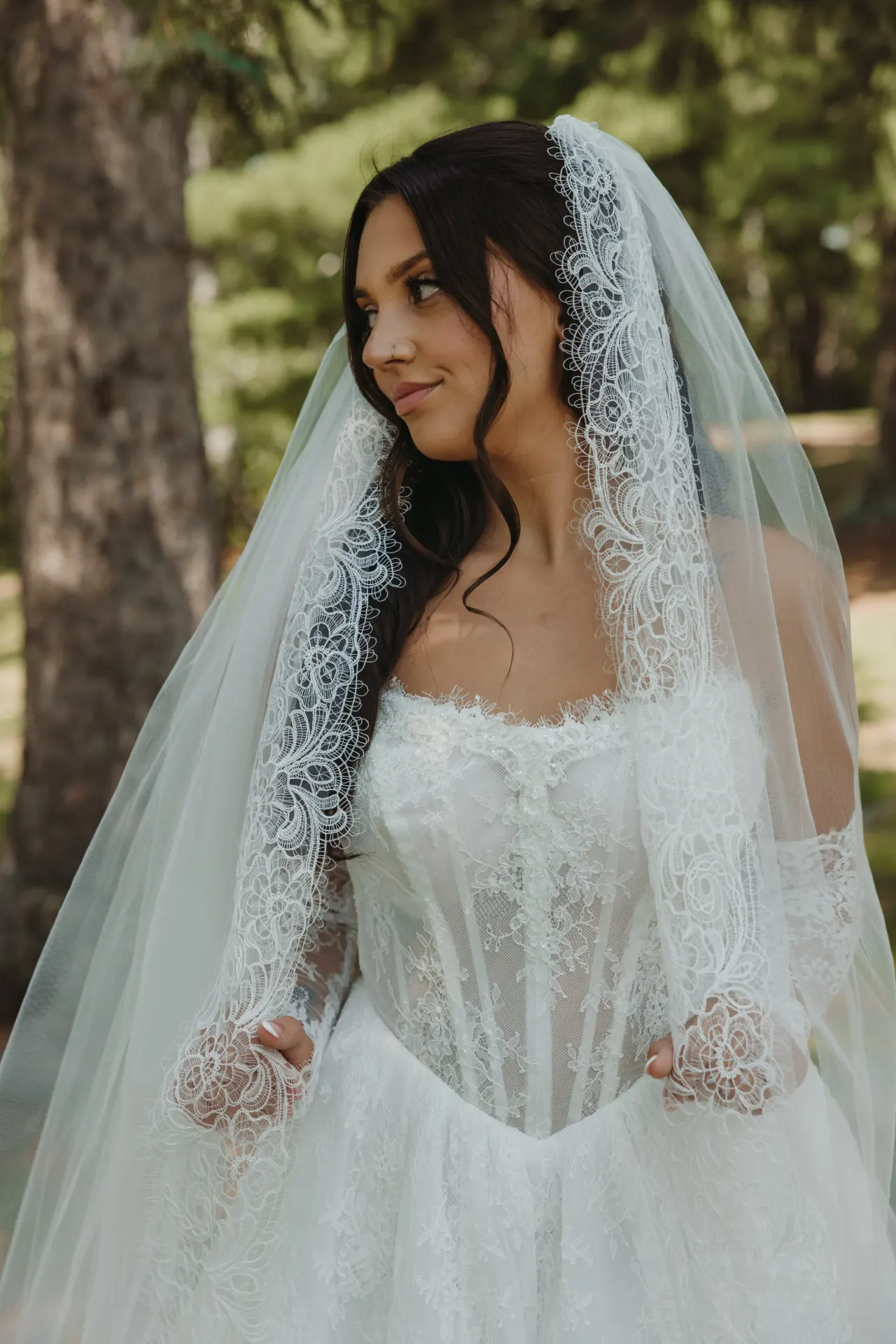 Bride in a lace-edged mantilla veil among tall pines — Minneapolis & Twin Cities wedding photography by Emma Ziegler, Honey Deww Photography (Minnesota)