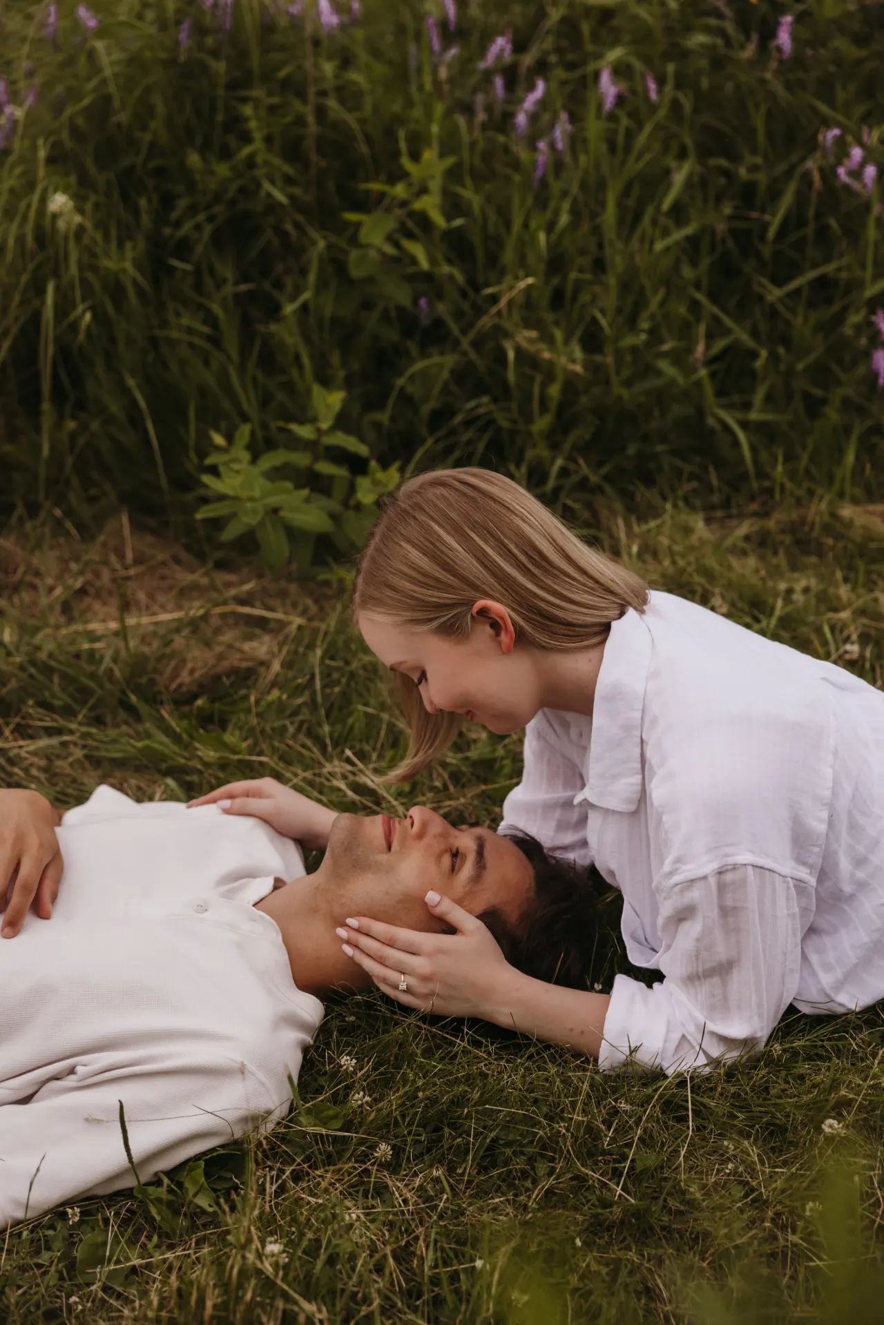 Couple lying in a wildflower meadow, one leaning over the other — Minneapolis & Twin Cities wedding photography by Emma Ziegler, Honey Deww Photography (Minnesota)