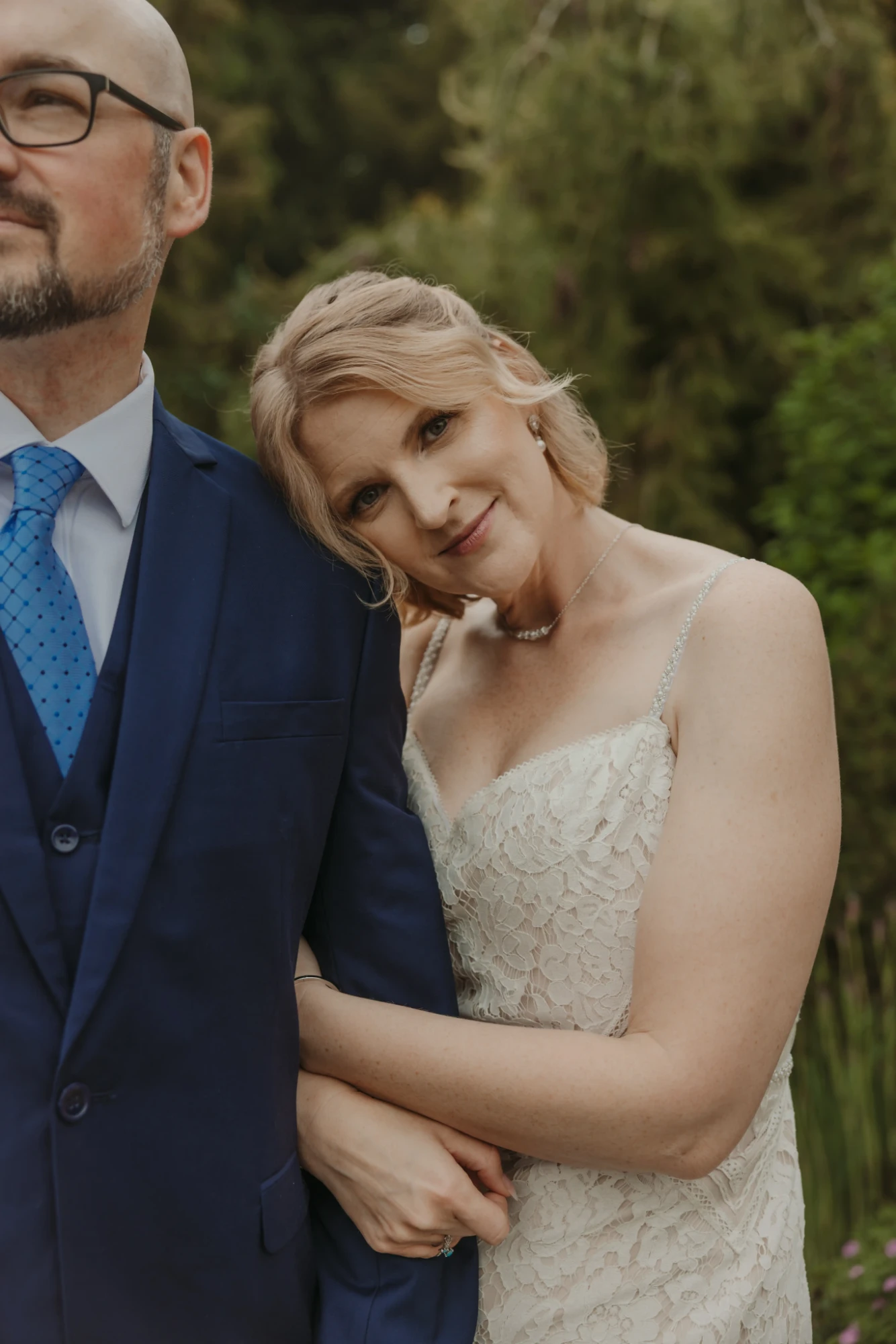 Bride resting her head on the groom's shoulder