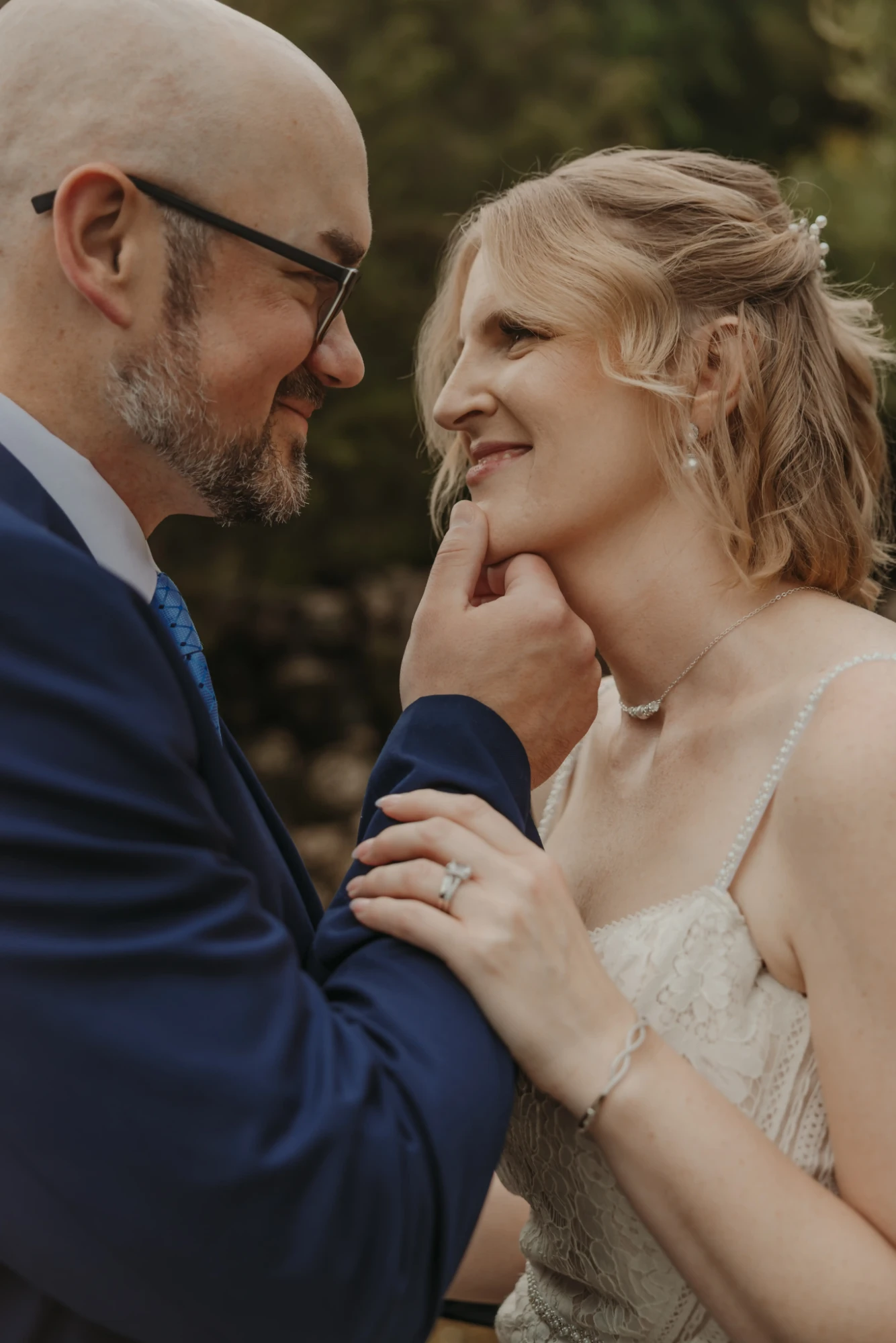 Groom lifting the bride's chin, both smiling