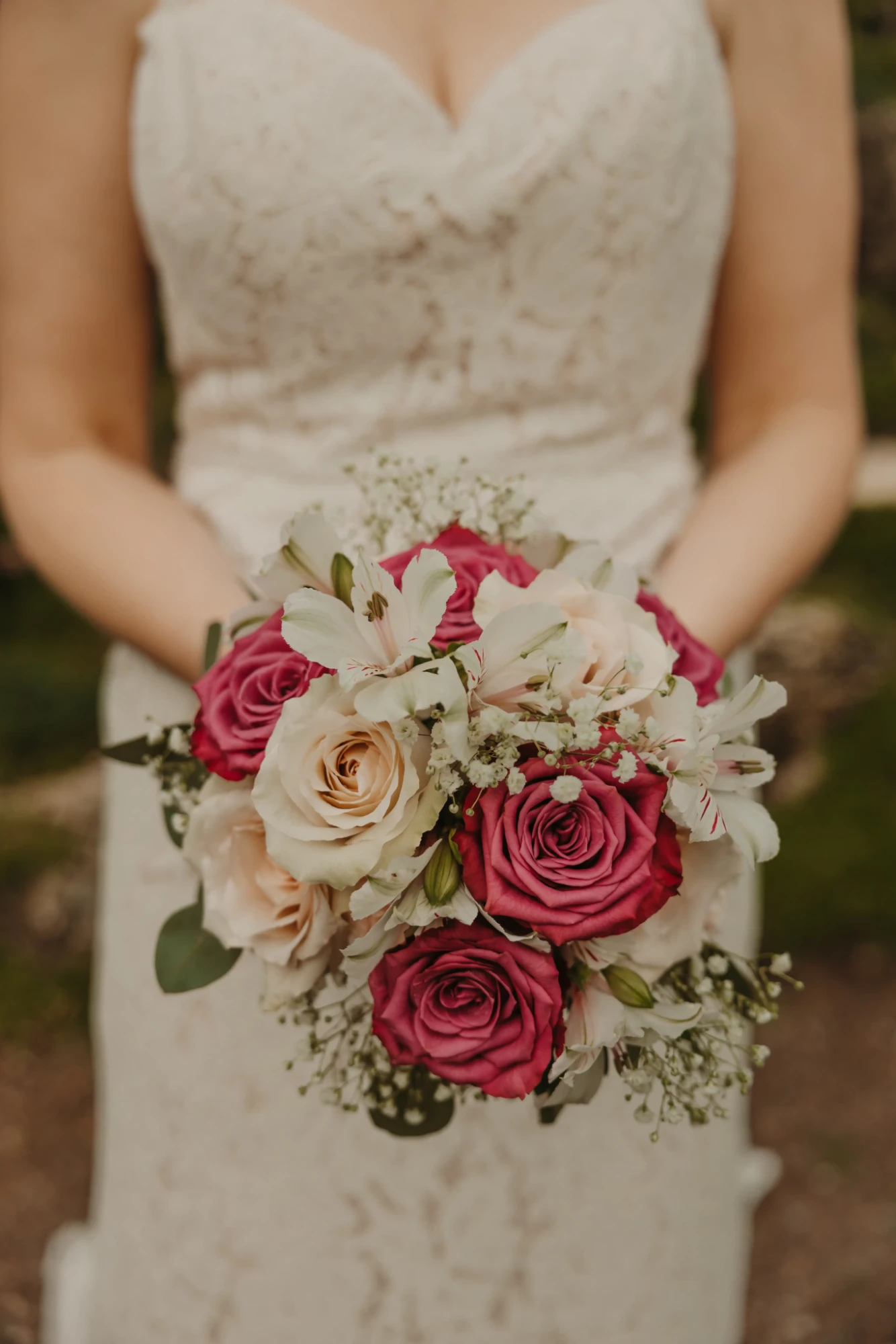 Close-up of the bouquet: pink and blush roses, white alstroemeria, baby's breath and eucalyptus